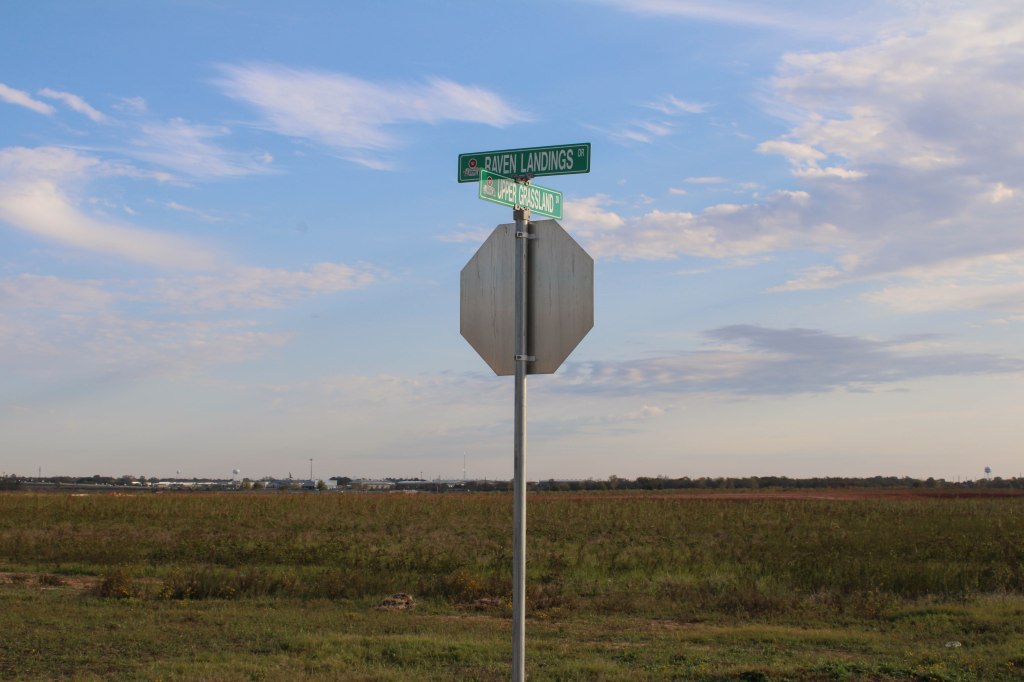 A stop sign marks the end of a newly named road in a new Waller housing development, which currently leads to an empty field. Rebecca Butler/Reporting Texas
